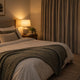 Quiet, cool and dark bedroom arranged to support better sleep
