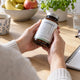 Dietary supplement bottles and a written checklist for reviewing evidence, dose and interactions